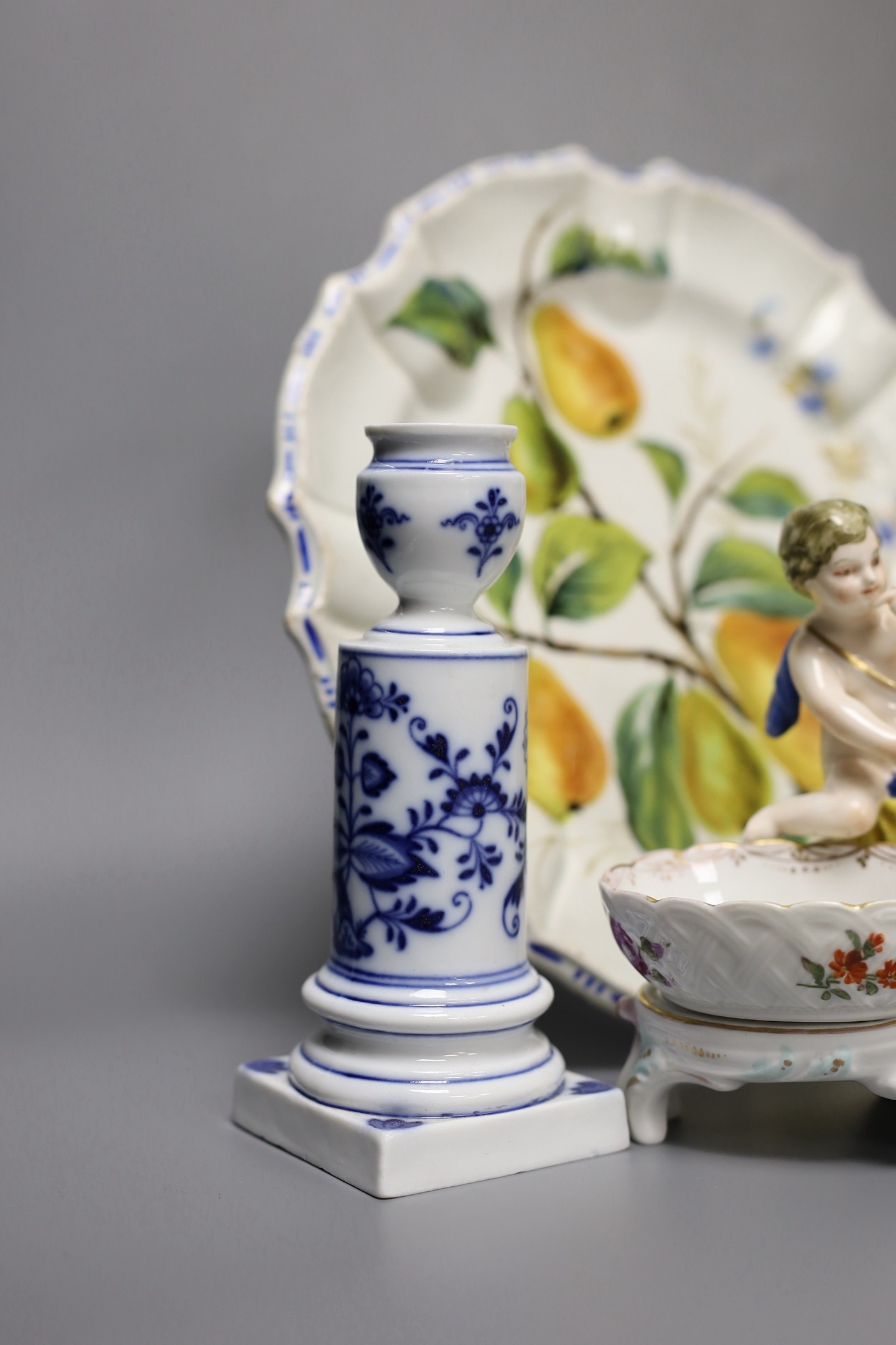 A pair of Meissen onion pattern candlesticks, 14 cm high, a Berlin figural salt, two Nove maiolica plates and a Richard Gingrich cache pot